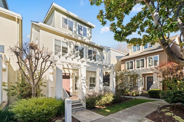 townhome / multi-family property featuring a pergola