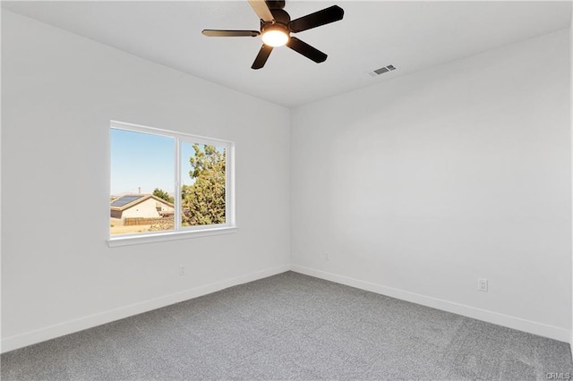 carpeted empty room featuring ceiling fan