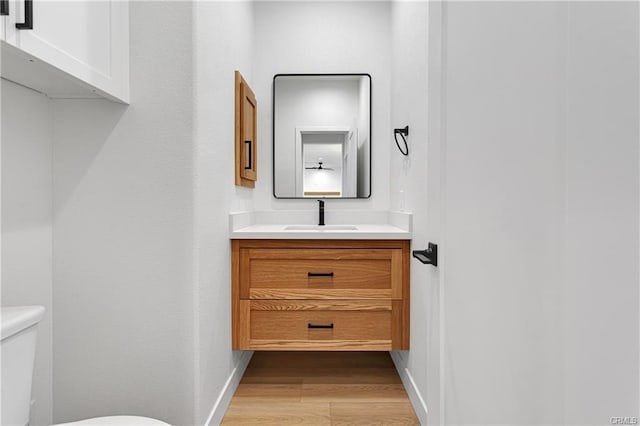 18554 Temecula Ave, Hesperia, CA 92345 - bathroom with wood finished floors, toilet, vanity, and baseboards