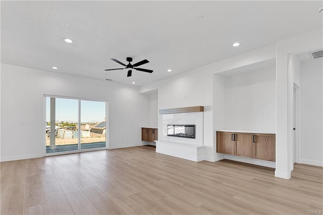 18554 Temecula Ave, Hesperia, CA 92345 - unfurnished living room featuring light wood-type flooring, ceiling fan, recessed lighting, a premium fireplace, and baseboards