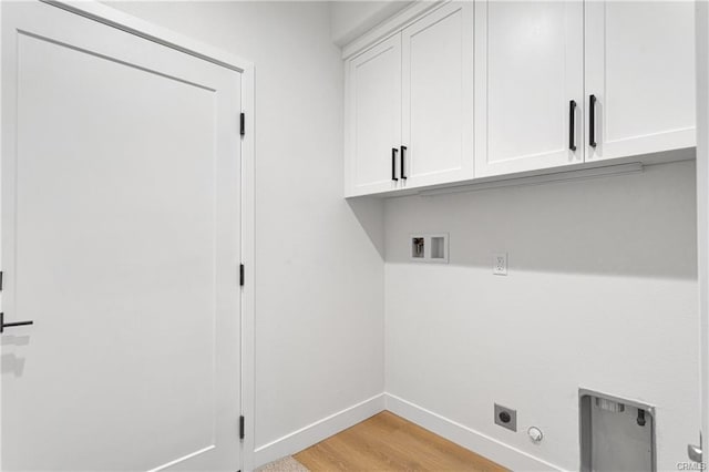 clothes washing area with cabinets, light hardwood / wood-style flooring, hookup for a washing machine, hookup for an electric dryer, and hookup for a gas dryer