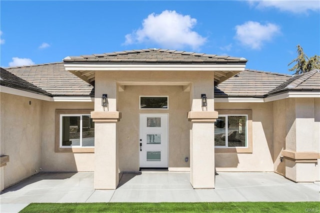 18554 Temecula Ave, Hesperia, CA 92345 - entrance to property with stucco siding, a patio, and a tiled roof