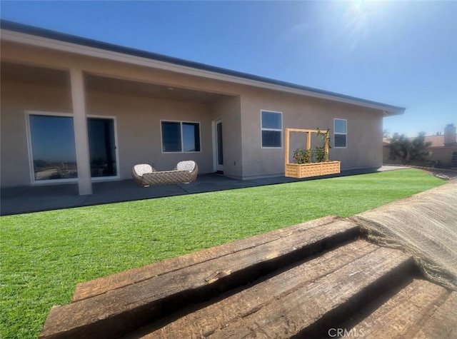 18554 Temecula Ave, Hesperia, CA 92345 - rear view of house featuring stucco siding, a yard, and a patio