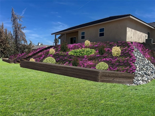 18554 Temecula Ave, Hesperia, CA 92345 - view of home's exterior featuring stucco siding, a yard, and central AC