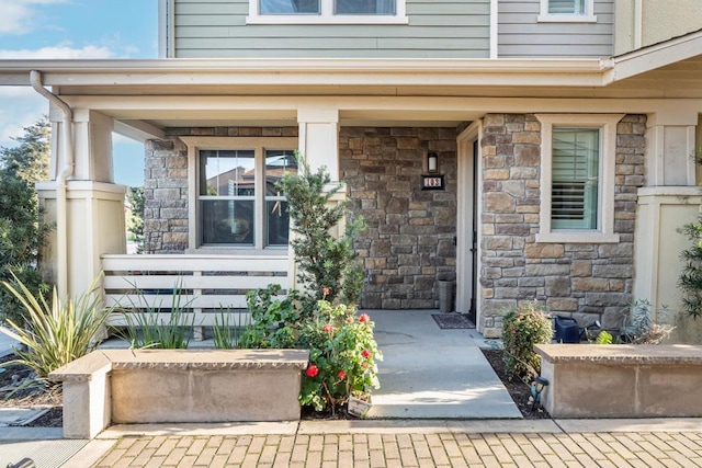 property entrance with covered porch