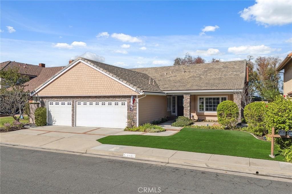 ranch-style home with a garage and a front yard