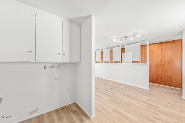 clothes washing area with light hardwood / wood-style floors