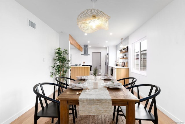 dining room featuring sink and light wood-type flooring