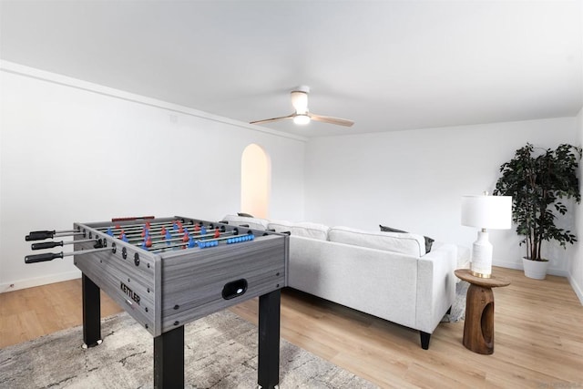 rec room with ceiling fan and light hardwood / wood-style flooring