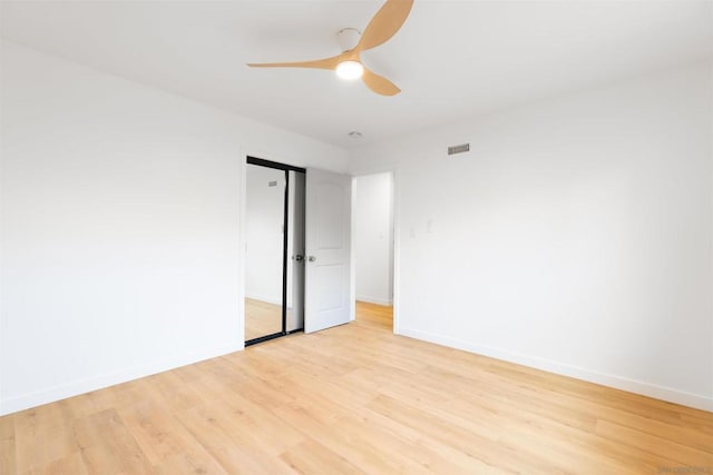 empty room featuring ceiling fan and light hardwood / wood-style flooring