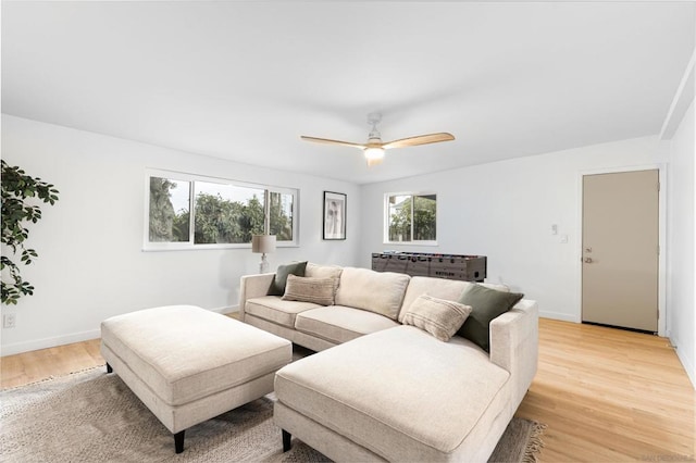 living room featuring ceiling fan and light wood-type flooring