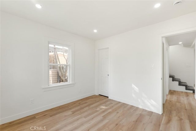 empty room with light hardwood / wood-style floors