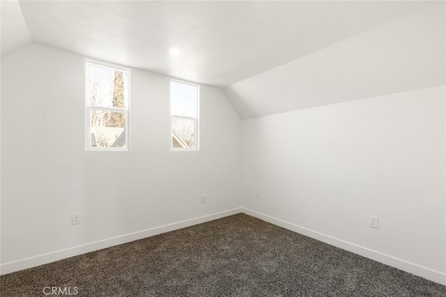 bonus room with lofted ceiling and carpet