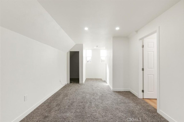 bonus room featuring light colored carpet