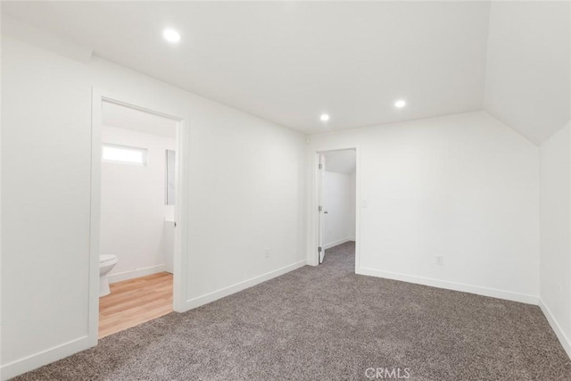 interior space featuring carpet and ensuite bath