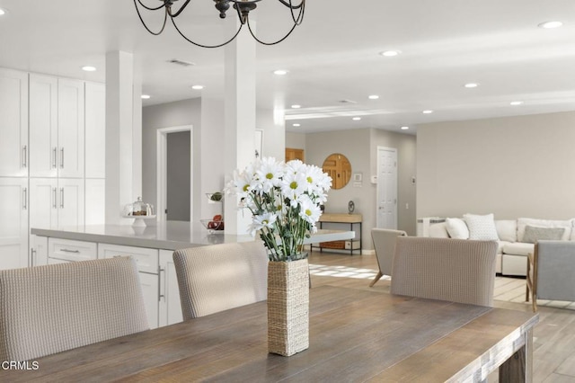 dining space with a chandelier and light hardwood / wood-style floors