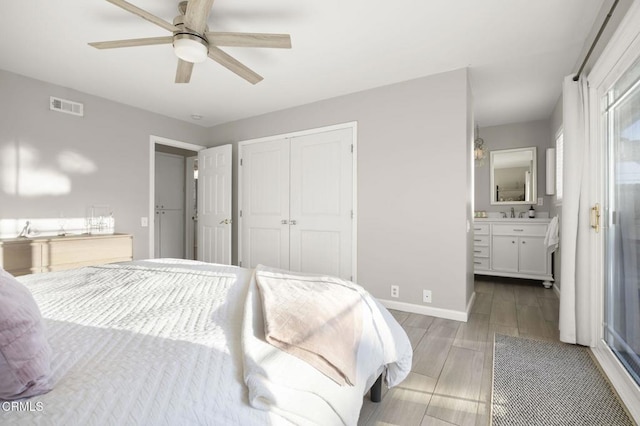 bedroom with hardwood / wood-style flooring, ensuite bath, a closet, and ceiling fan