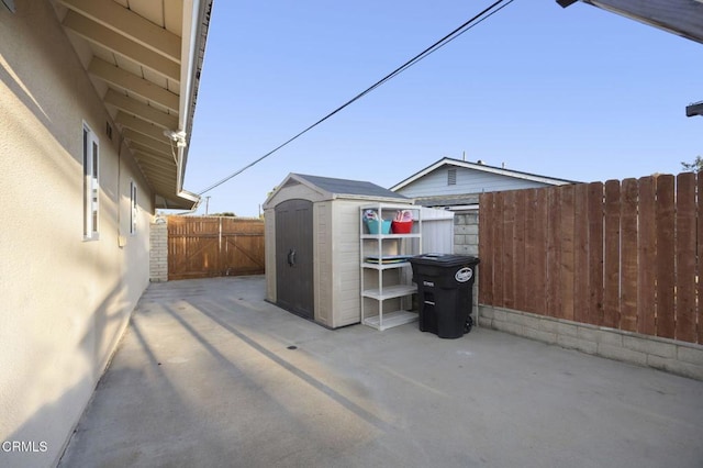 view of patio featuring a storage unit