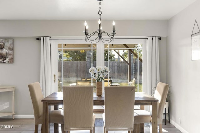 dining space featuring an inviting chandelier and wood-type flooring