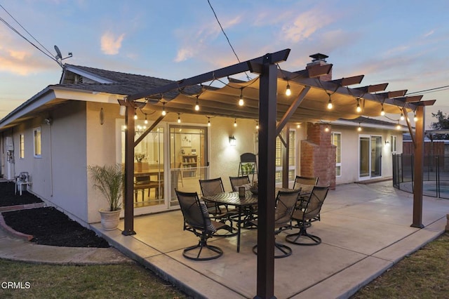 patio terrace at dusk with a pergola