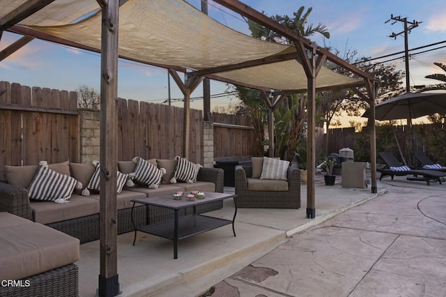 patio terrace at dusk featuring an outdoor living space