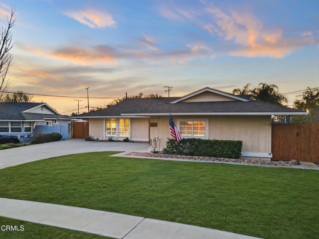 ranch-style home with a lawn