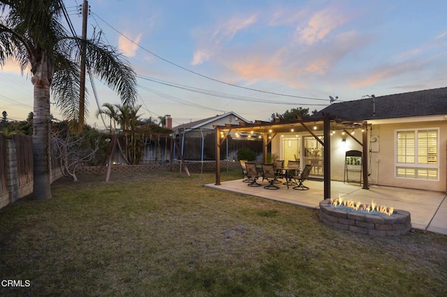 yard at dusk with a fire pit and a patio