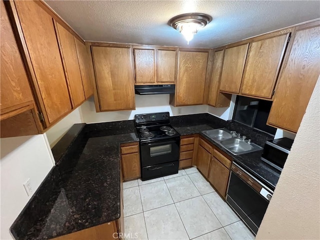 kitchen featuring ventilation hood, sink, light tile patterned floors, black appliances, and a textured ceiling