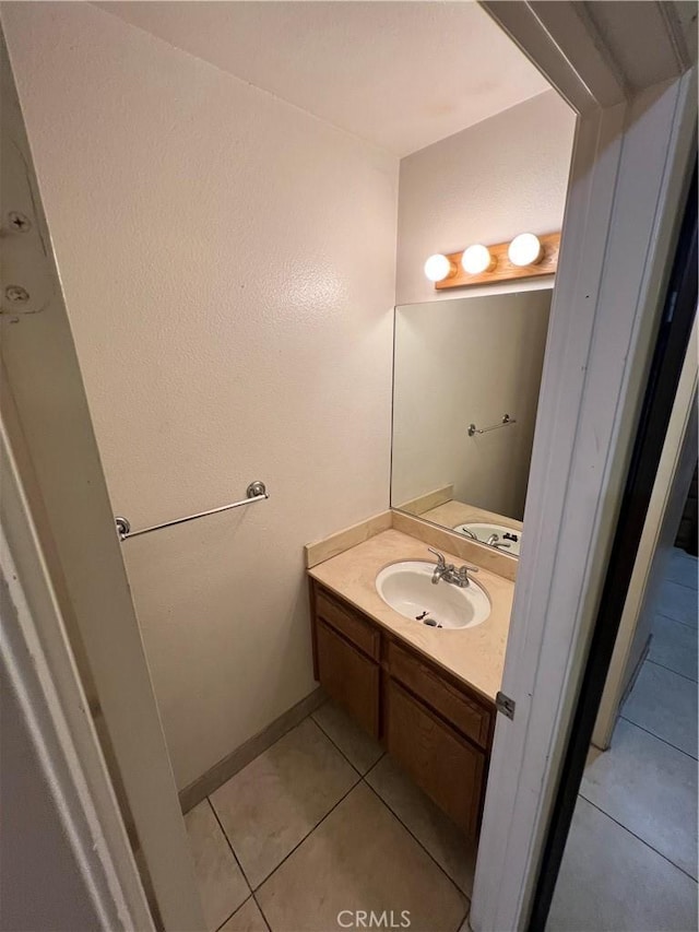 bathroom with tile patterned floors and vanity