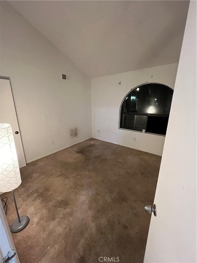 unfurnished living room with vaulted ceiling