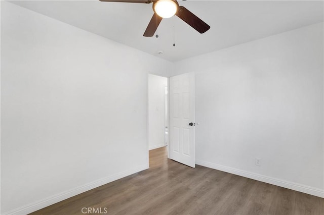 spare room featuring hardwood / wood-style flooring and ceiling fan