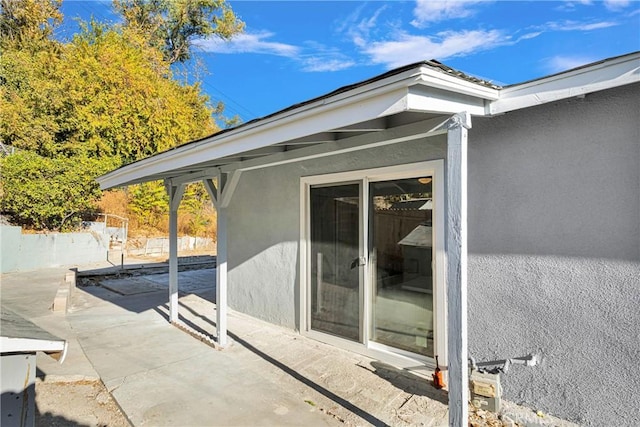 view of side of home with a patio