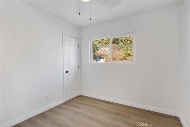 empty room with light hardwood / wood-style flooring