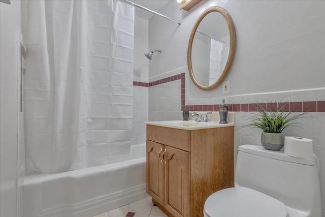 full bathroom featuring tile patterned floors, toilet, tile walls, vanity, and shower / bathtub combination with curtain