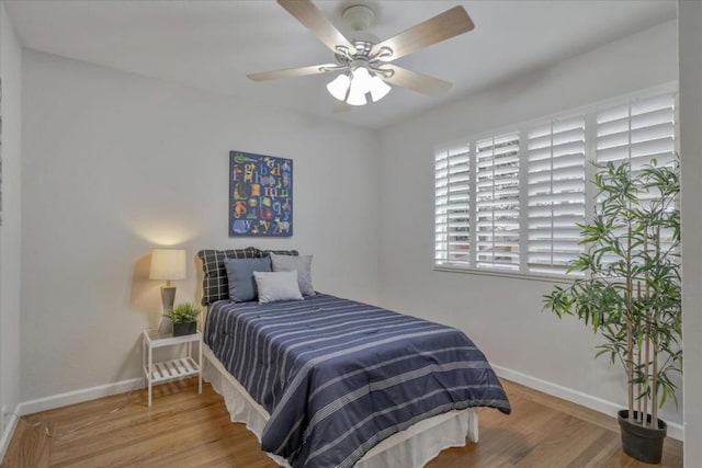 bedroom with wood-type flooring and ceiling fan