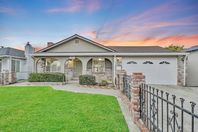 single story home featuring a garage, a yard, and covered porch