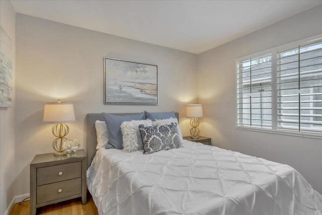 bedroom featuring multiple windows and light wood-type flooring