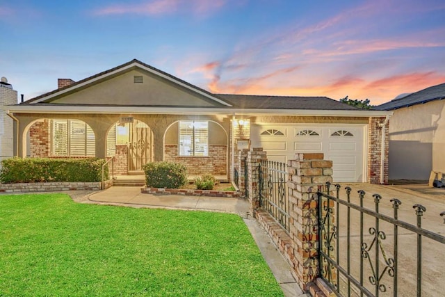 single story home featuring a yard and a garage