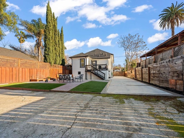 rear view of property featuring a patio area