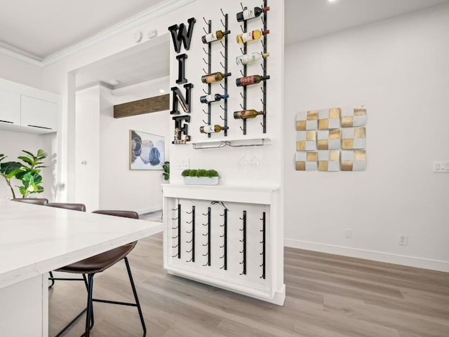 dining room featuring crown molding and light hardwood / wood-style floors