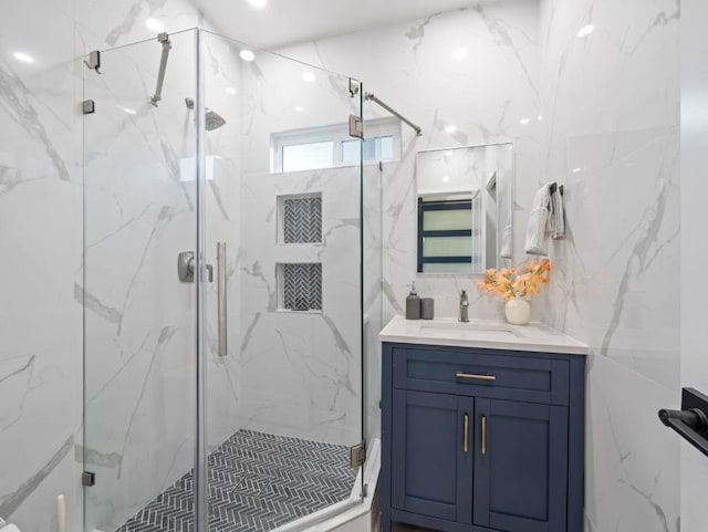 bathroom with vanity and a shower with door