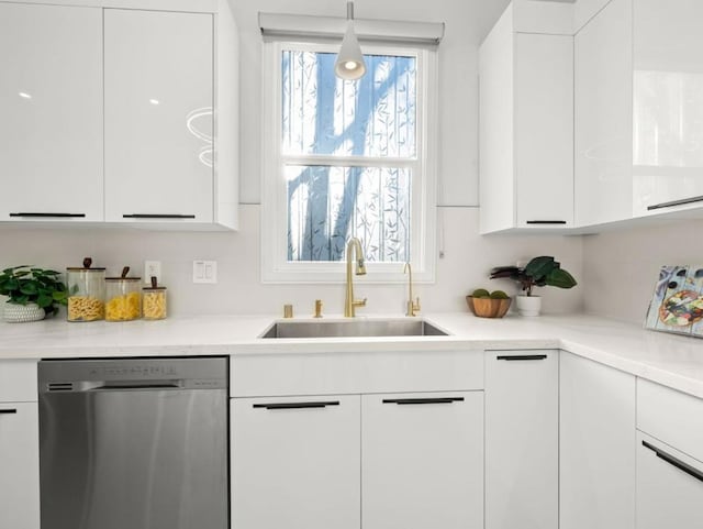 kitchen with white cabinetry, stainless steel dishwasher, sink, and hanging light fixtures