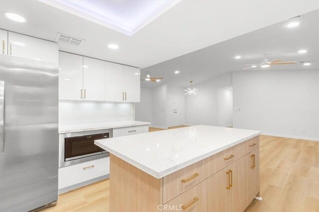 2173 N Viminal Rd, Palm Springs, CA 92262 - kitchen featuring freestanding refrigerator, light wood-style flooring, recessed lighting, a kitchen island, and tasteful backsplash