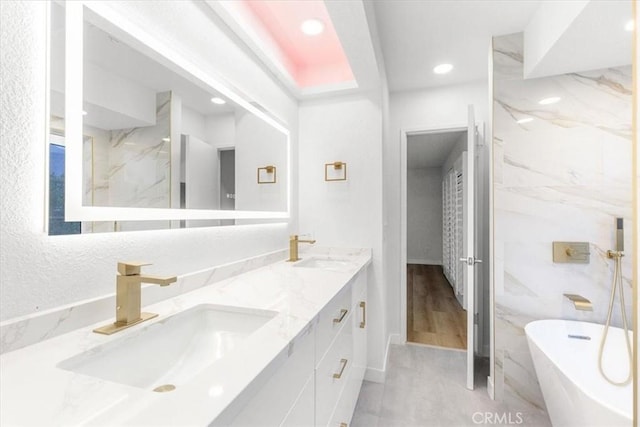 bathroom with a bathing tub and vanity