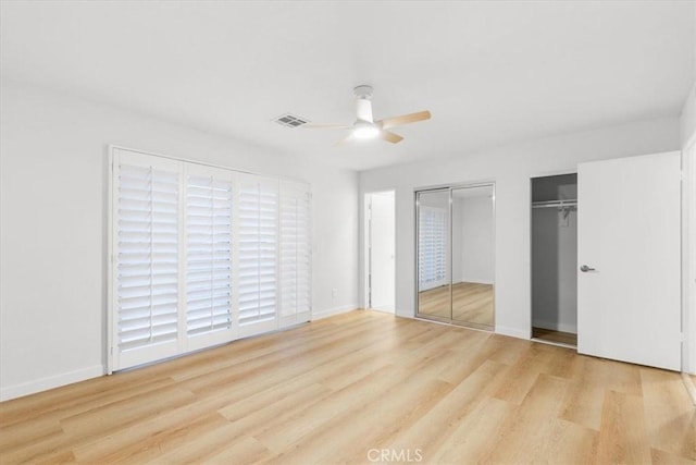 2173 N Viminal Rd, Palm Springs, CA 92262 - unfurnished bedroom featuring two closets, wood finished floors, baseboards, and a ceiling fan