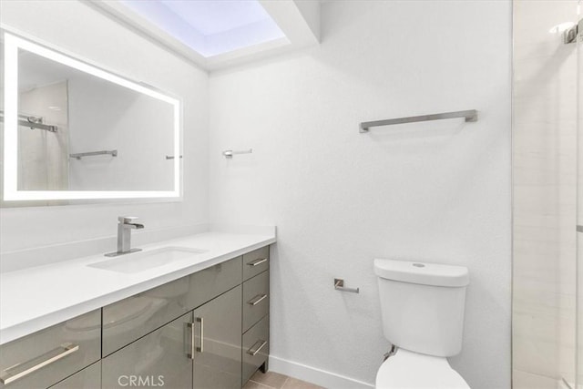 bathroom featuring vanity, an enclosed shower, and toilet