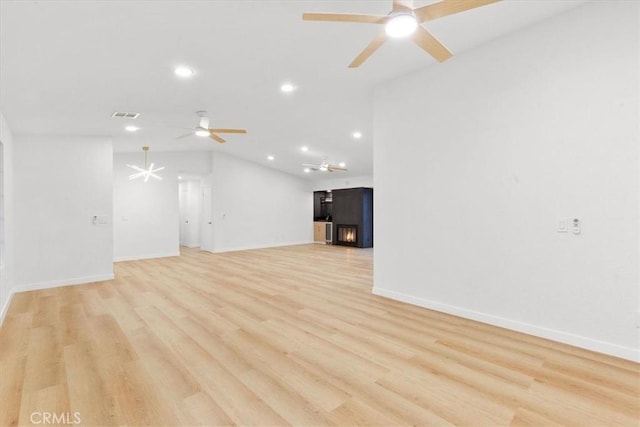 2173 N Viminal Rd, Palm Springs, CA 92262 - unfurnished living room with ceiling fan, recessed lighting, baseboards, light wood-type flooring, and vaulted ceiling