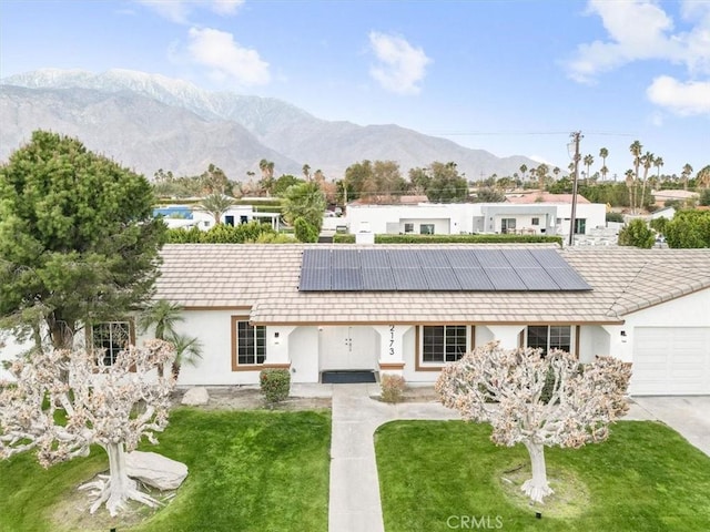 2173 N Viminal Rd, Palm Springs, CA 92262 - ranch-style home with a front yard, solar panels, stucco siding, a mountain view, and an attached garage