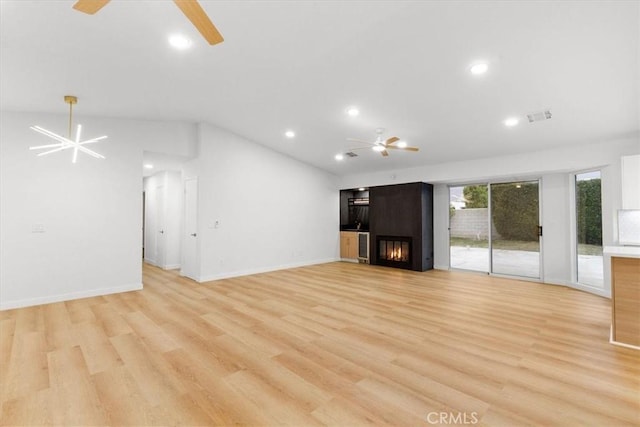 2173 N Viminal Rd, Palm Springs, CA 92262 - unfurnished living room featuring a ceiling fan, a large fireplace, lofted ceiling, recessed lighting, and light wood-style flooring