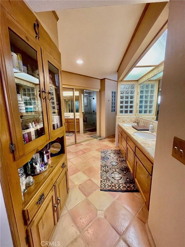 bathroom featuring vanity and decorative backsplash